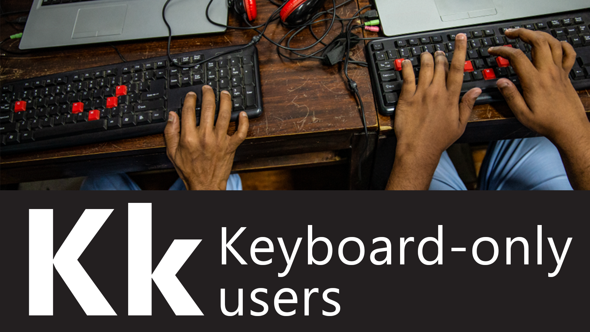 K is for keyboard-only users. Overhead view of two students using assistive technology to learn programming at vocational school for the blind.
