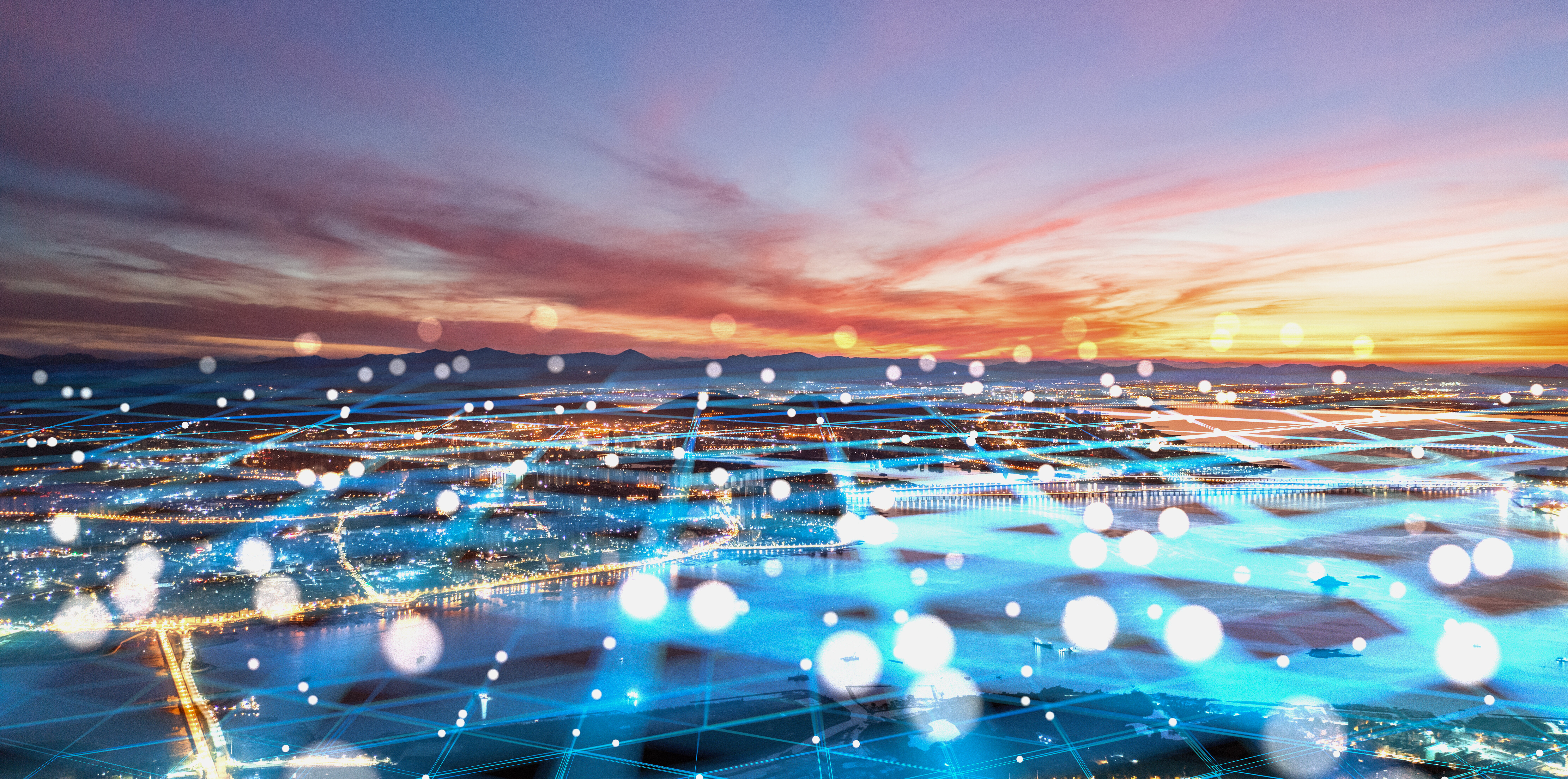 Cityscape at sunset with a glowing digital network overlay