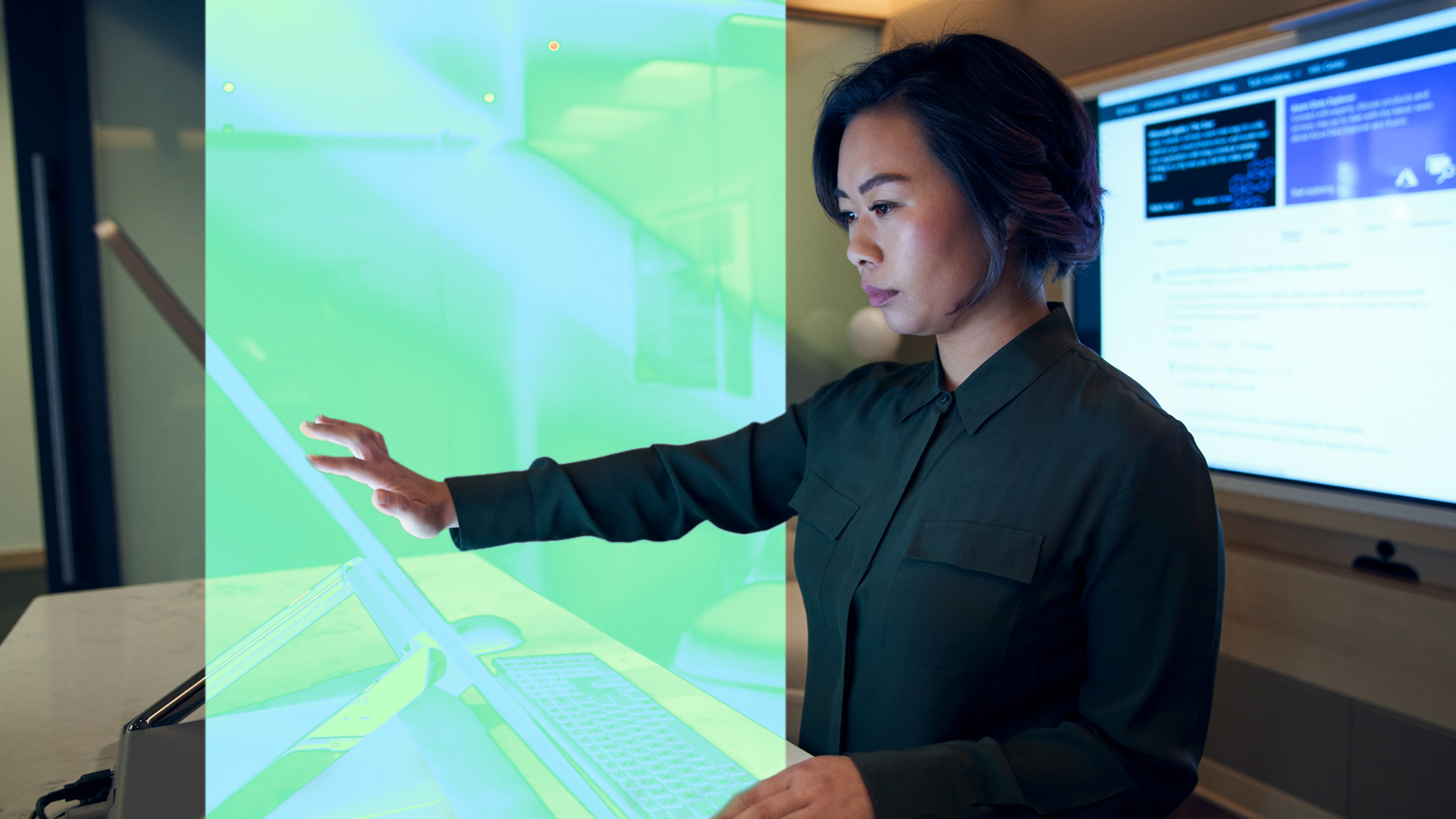 A person using a large interactive touchscreen in a modern office setting.