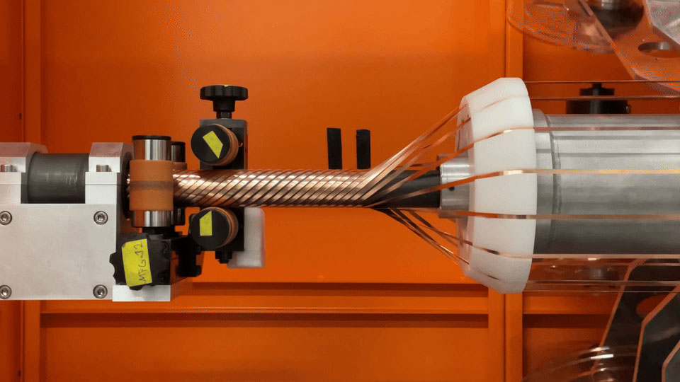 industrial machine winding braided cable onto a spool