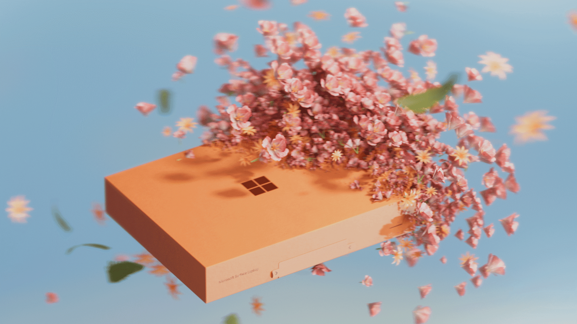 Orange Microsoft Surface laptop box with blossoms bursting and floating in the air.