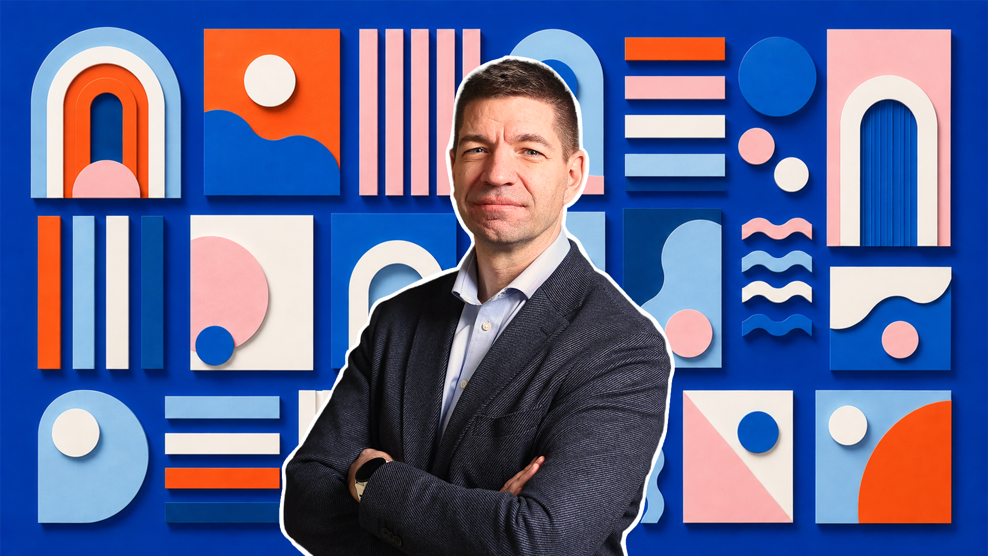 Portrait of a person with arms crossed in front of a blue background with colorful geometric shapes.