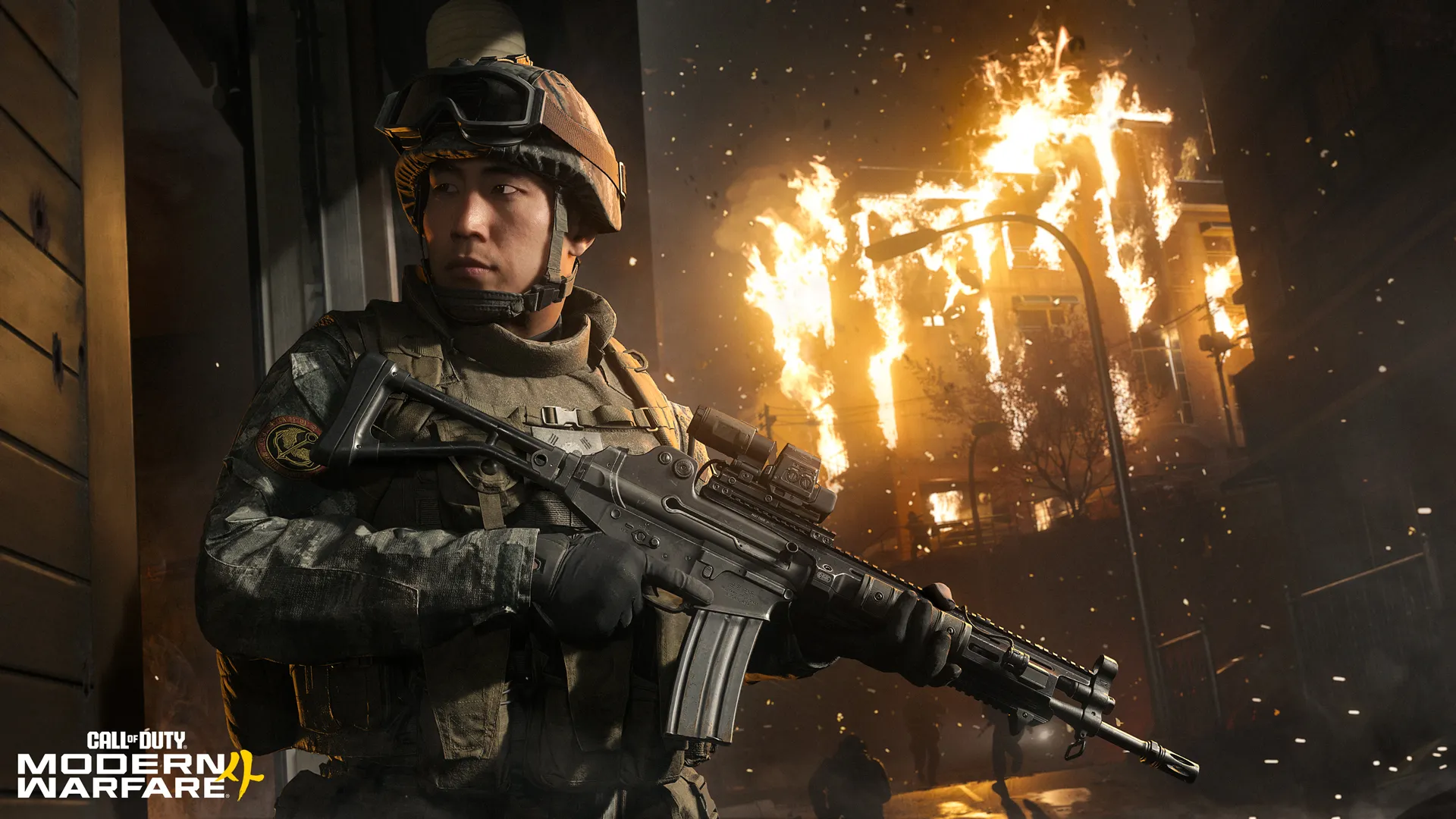 Soldier holding a rifle in a narrow street, with a building behind engulfed in flames and sparks in the air.