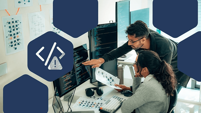 Two people reviewing code on computer monitors, with cybersecurity warning and coding icons overlaid.