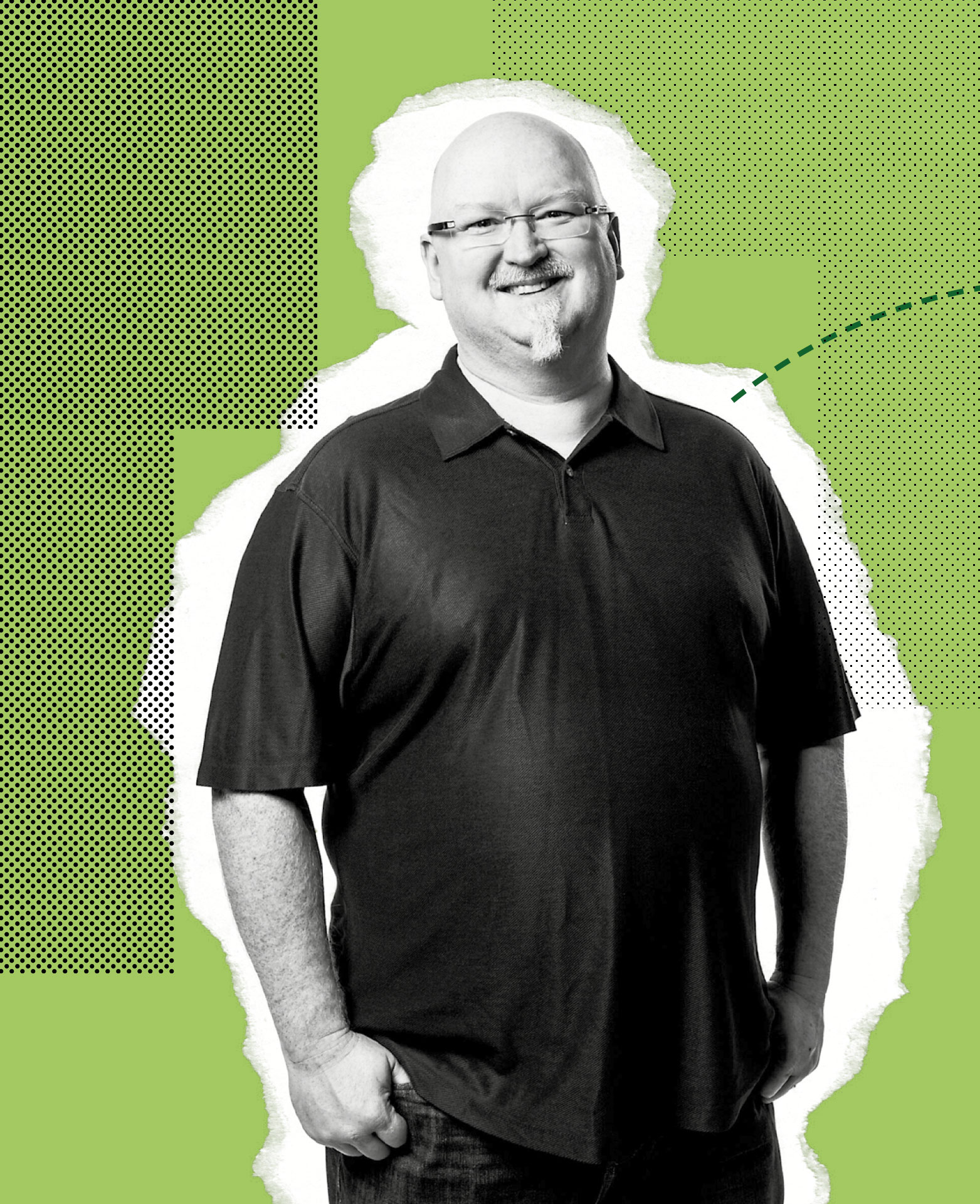 A smiling man with glasses and a goatee stands facing the camera, wearing a black polo shirt and jeans, against a green and black patterned background with graphic elements.