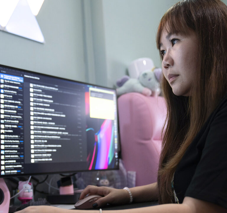 woman looking at computer monitors