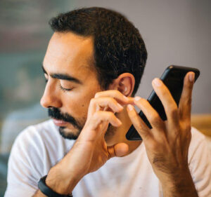 Man holding a smartphone close to his ear