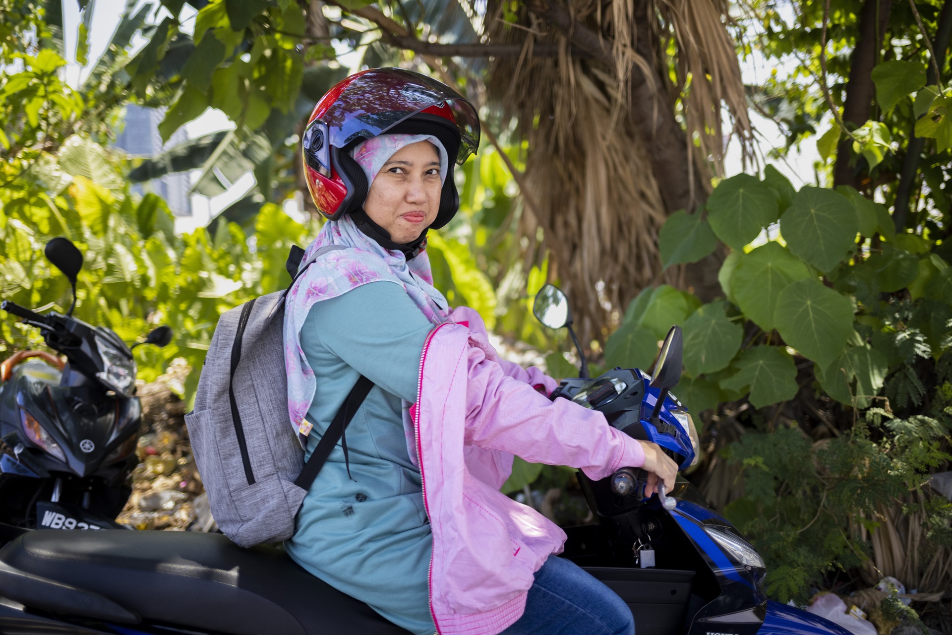 Woman in a headscarf on a scooter