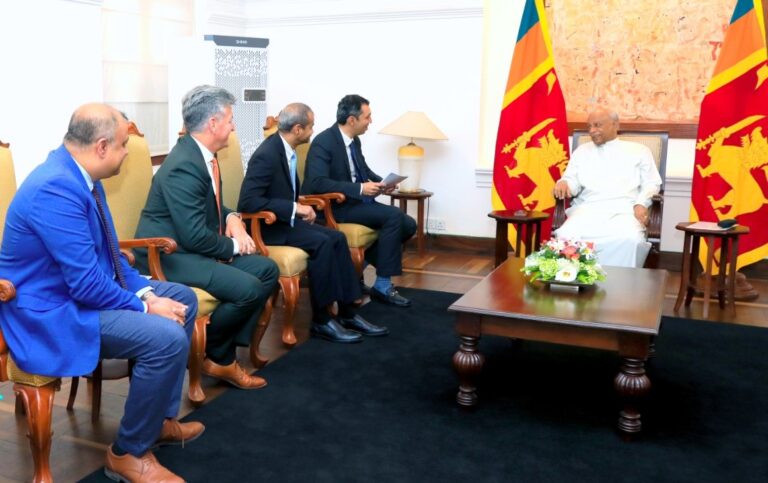 group of men in a meeting with a Sri Lankan government official