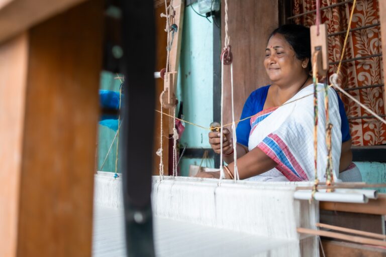 A person sitting in a weaving loom