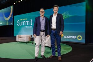 Two adult males, standing at the front of the stage at the Suncorp Summit