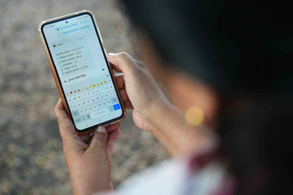 A woman holding a phone and reading the instructions written on the screen