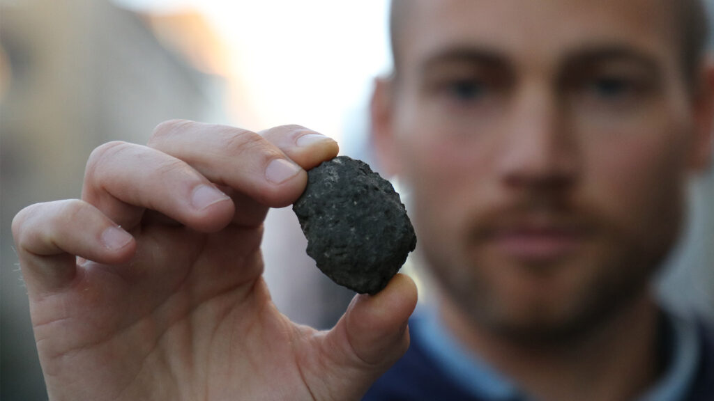 man holding carbon nugget