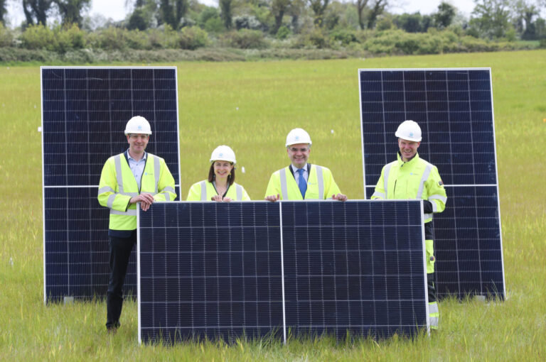 People smiling with solar panels
