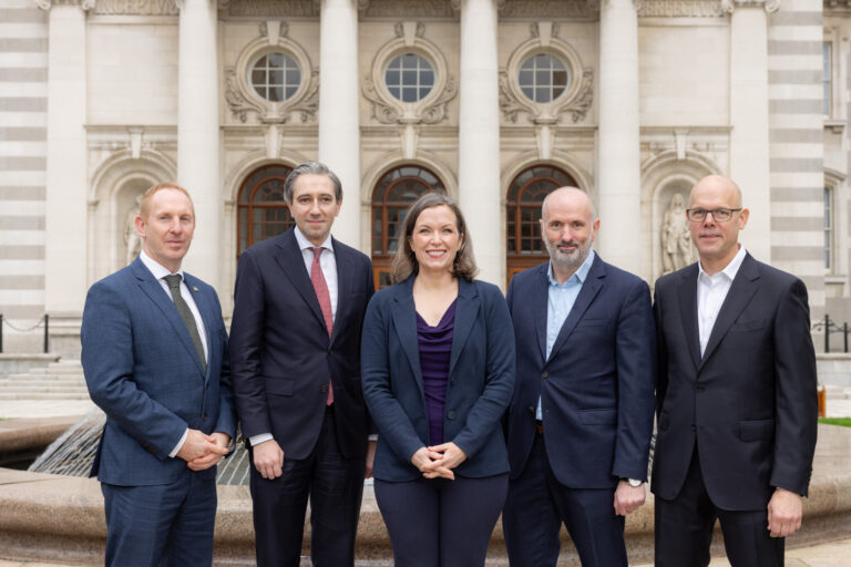 Five people standing in front of Government Buildings