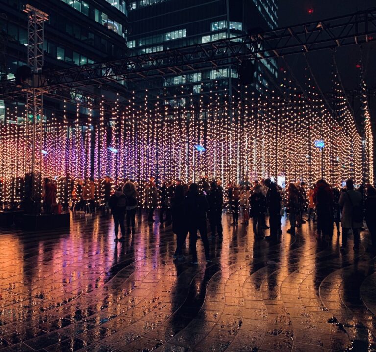 Grupos de personas se congregan en una plaza iluminada
