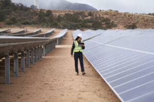 Una persona camina junto a paneles solares