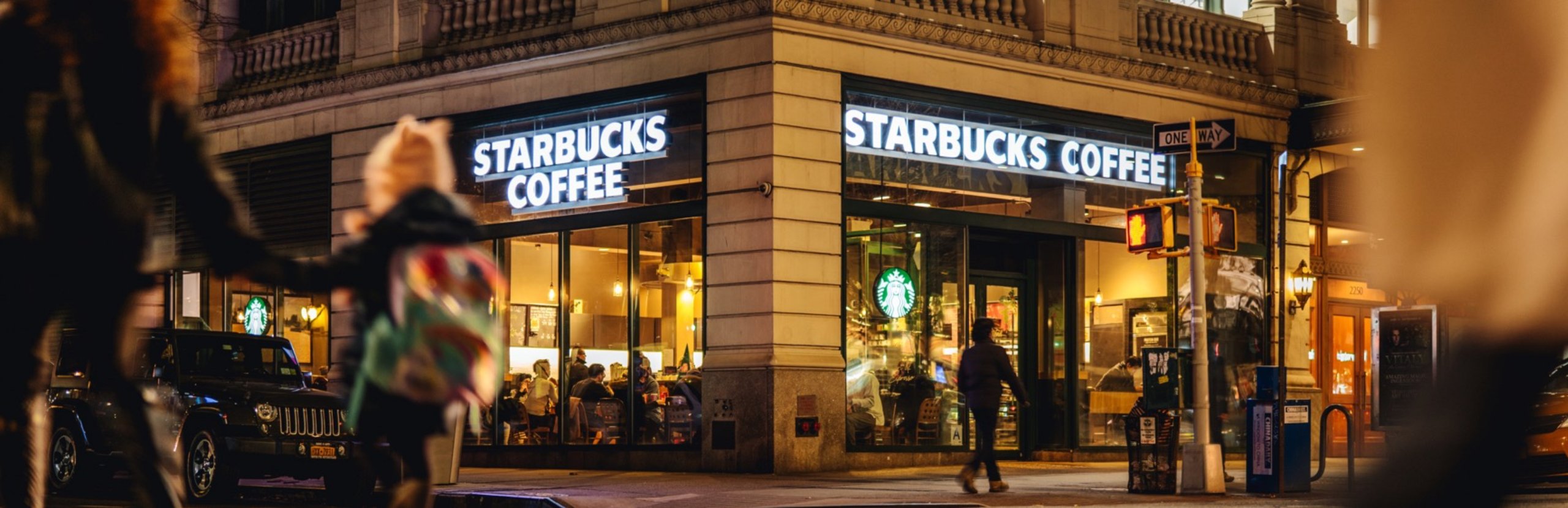 A Starbucks location shown at night.