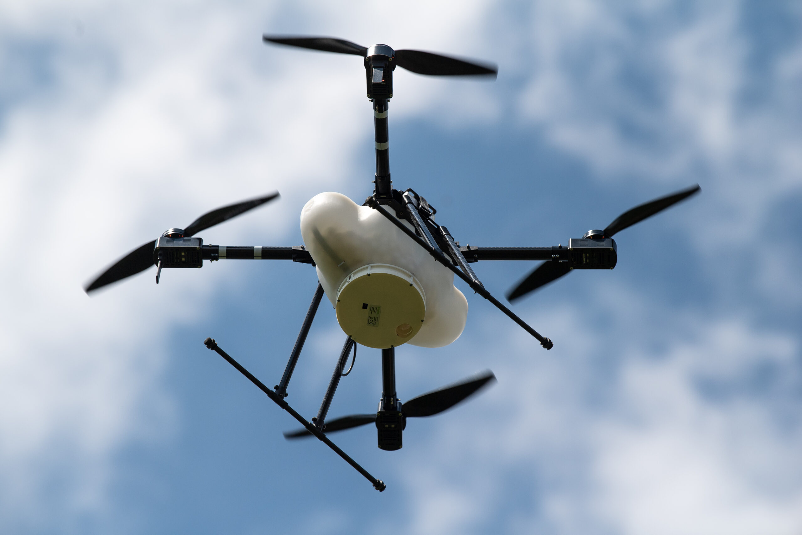 A hovering drone is shown from the bottom.
