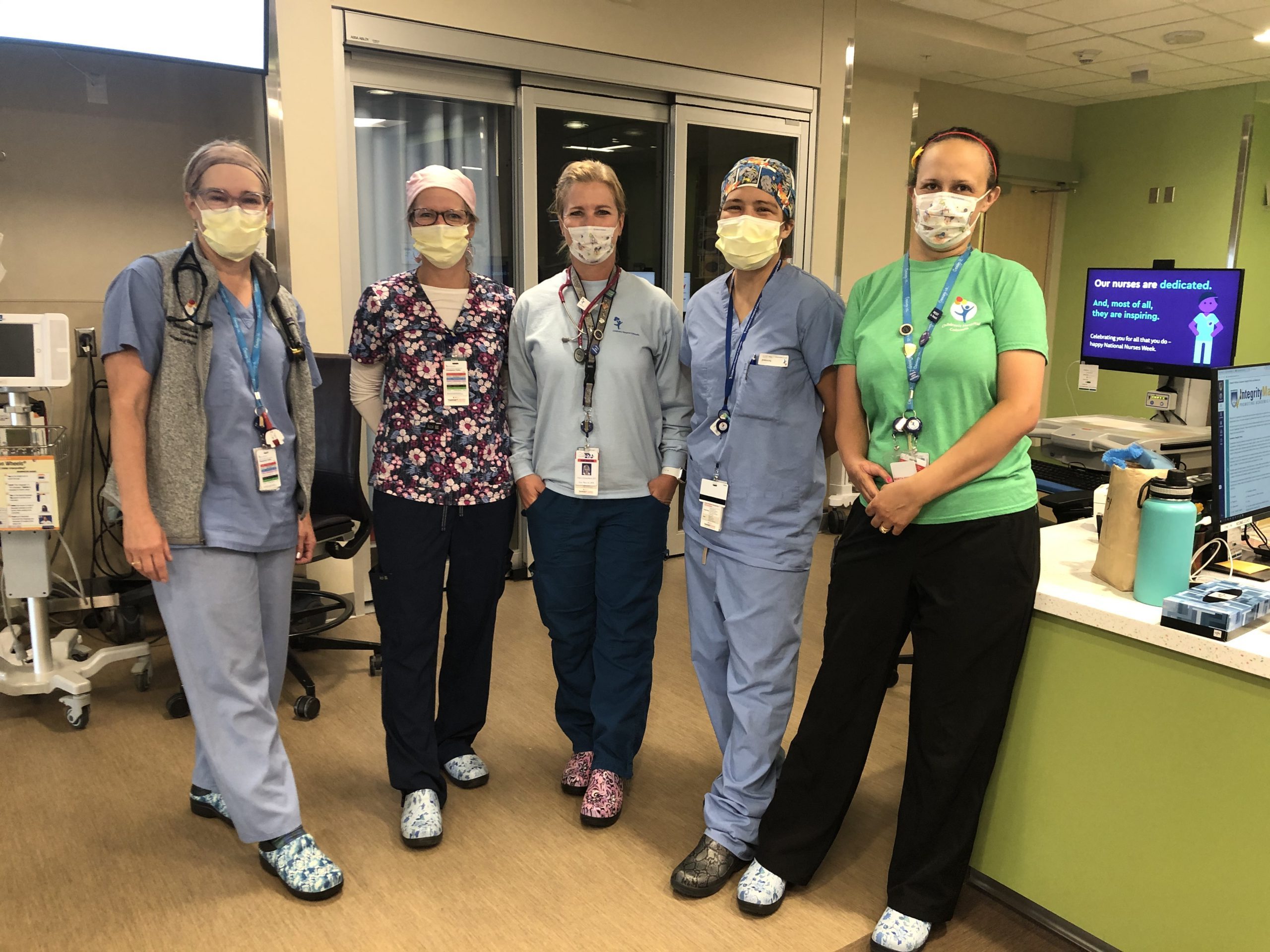 Photo of five workers at Children's Hospital Colorado wearing Crocs clogs donated by the company.