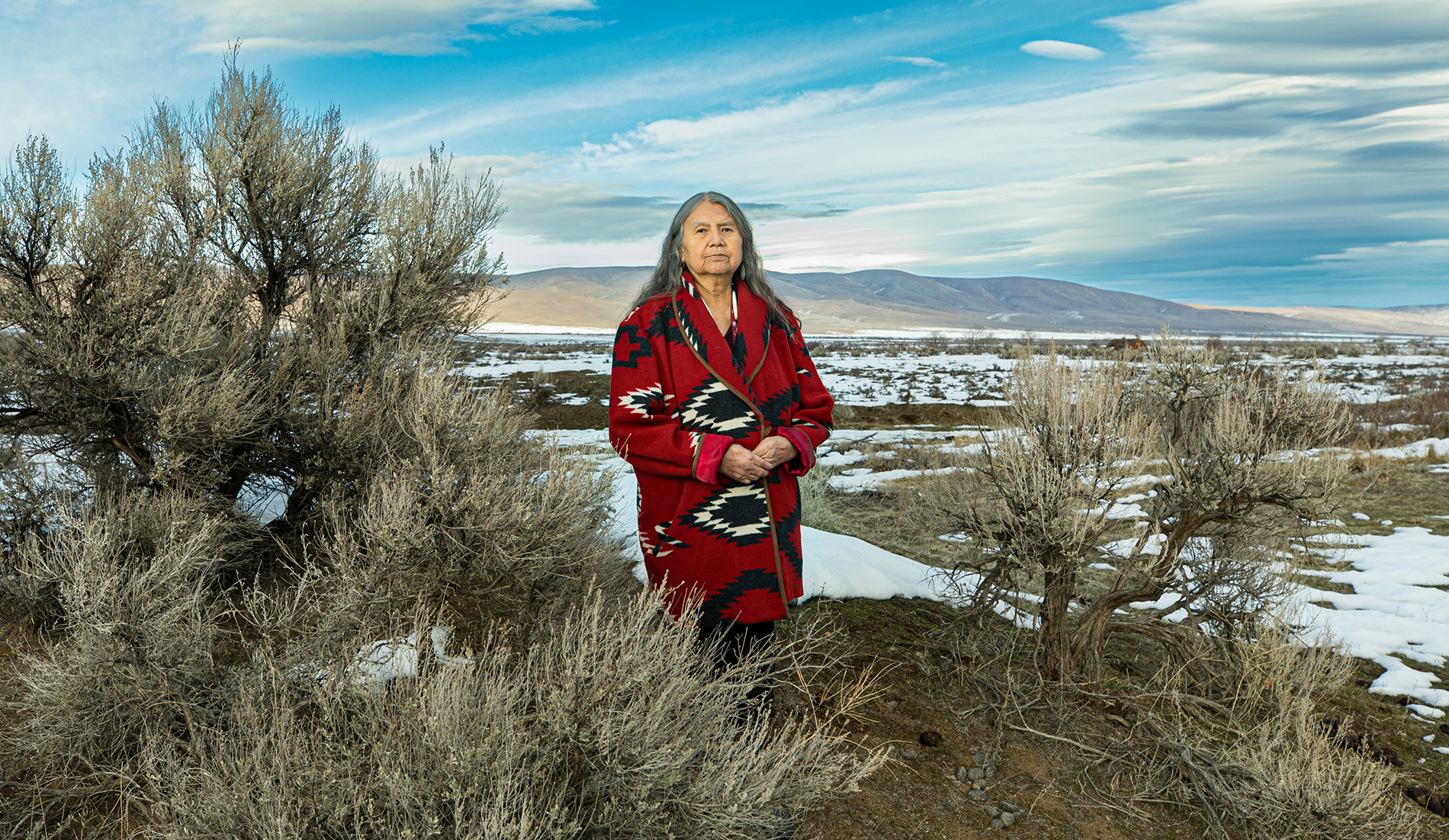 Woman stands in a field at the Yakama Reservation