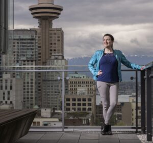 Portrait of Katie Peters of TELUS standing on an outdoor patio of a building in downtown Vancouver, B.C.