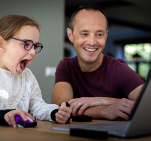 Father and daughter use laptop