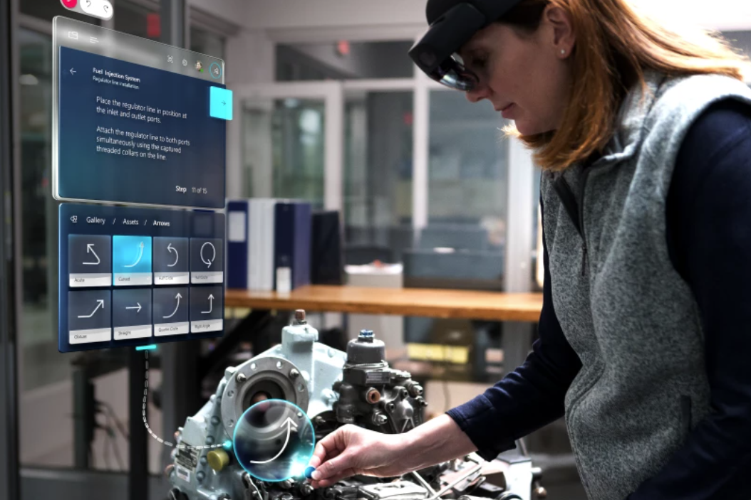 Woman wearing HoloLens to work on an engine