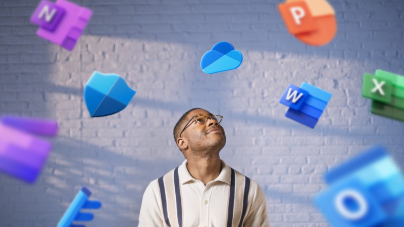 Man looking up as icons of Microsoft 365 programs float around him