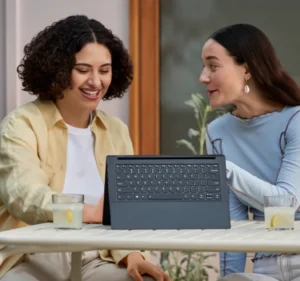 Two women working together on a tablet computer