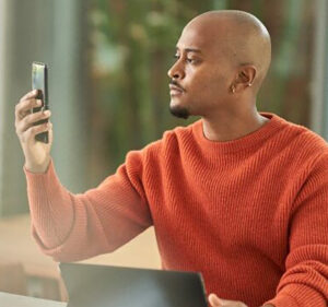 Man looking at his phone that he holds up to eye level