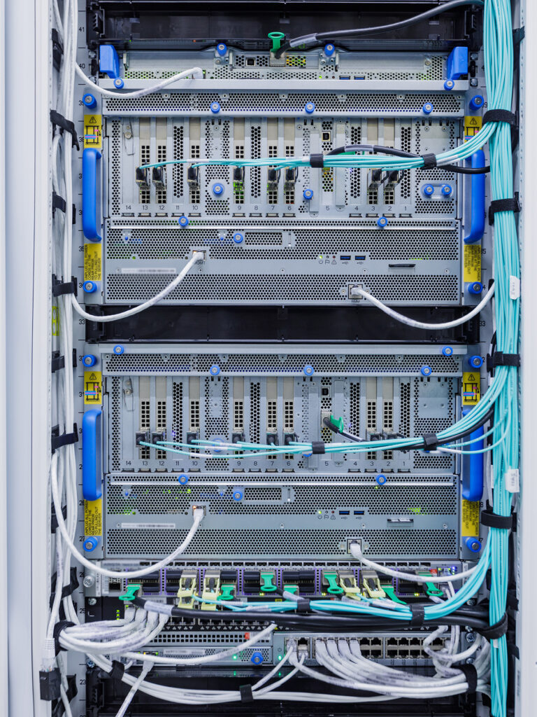 Closeup of a Graphics Processing Unit, known as a GPU, with networking cables attached.