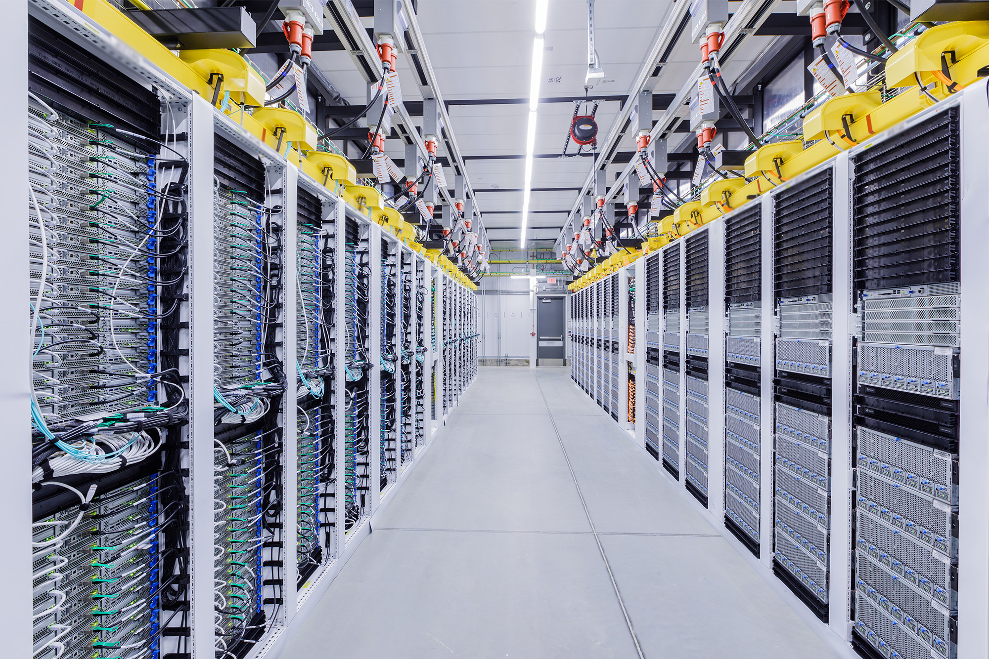 Racks of Graphics Processing Units, known as GPUs, are shown in a datacenter aisle.