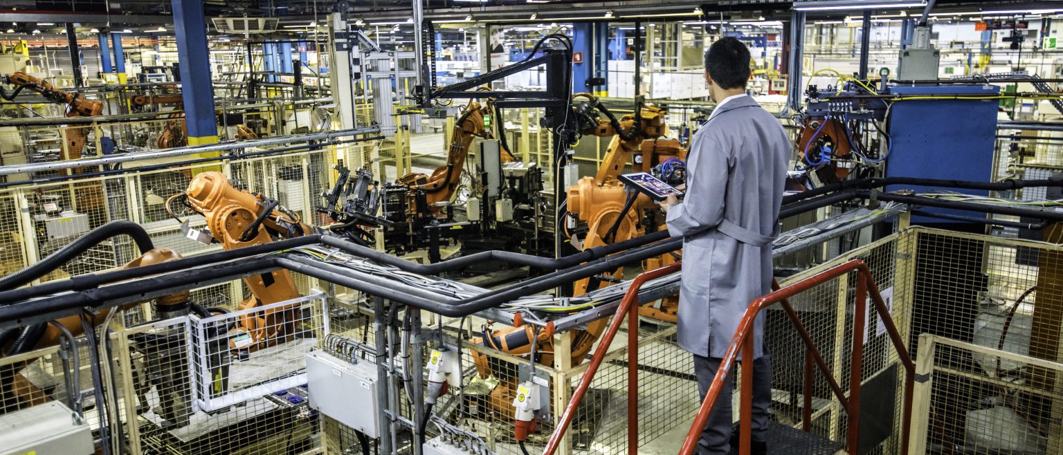 Engineer overseeing automated production process in a factory