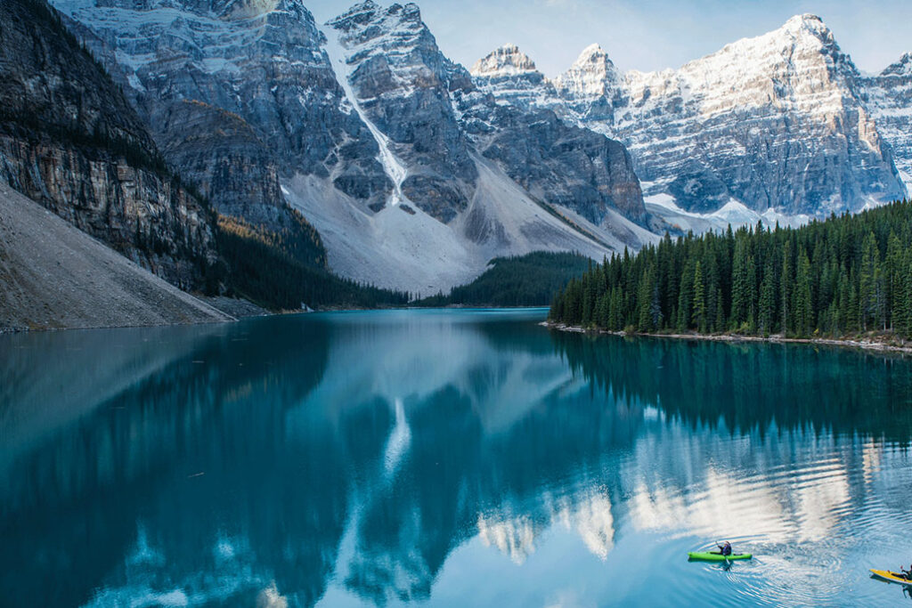 Canoers on a pictureque lake with a mountain backdrop