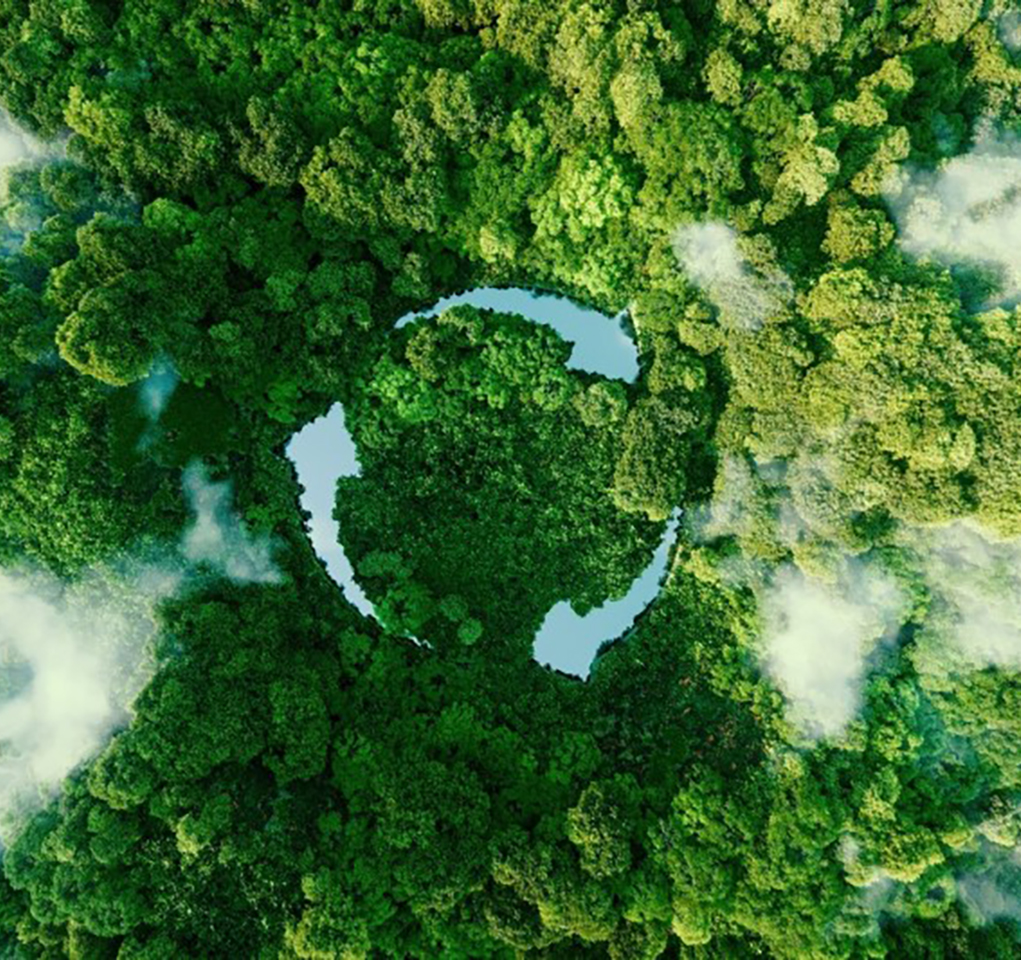 View of a forest from the air, with three lakes shaped like arrows forming a shape similar to the recycle symbol