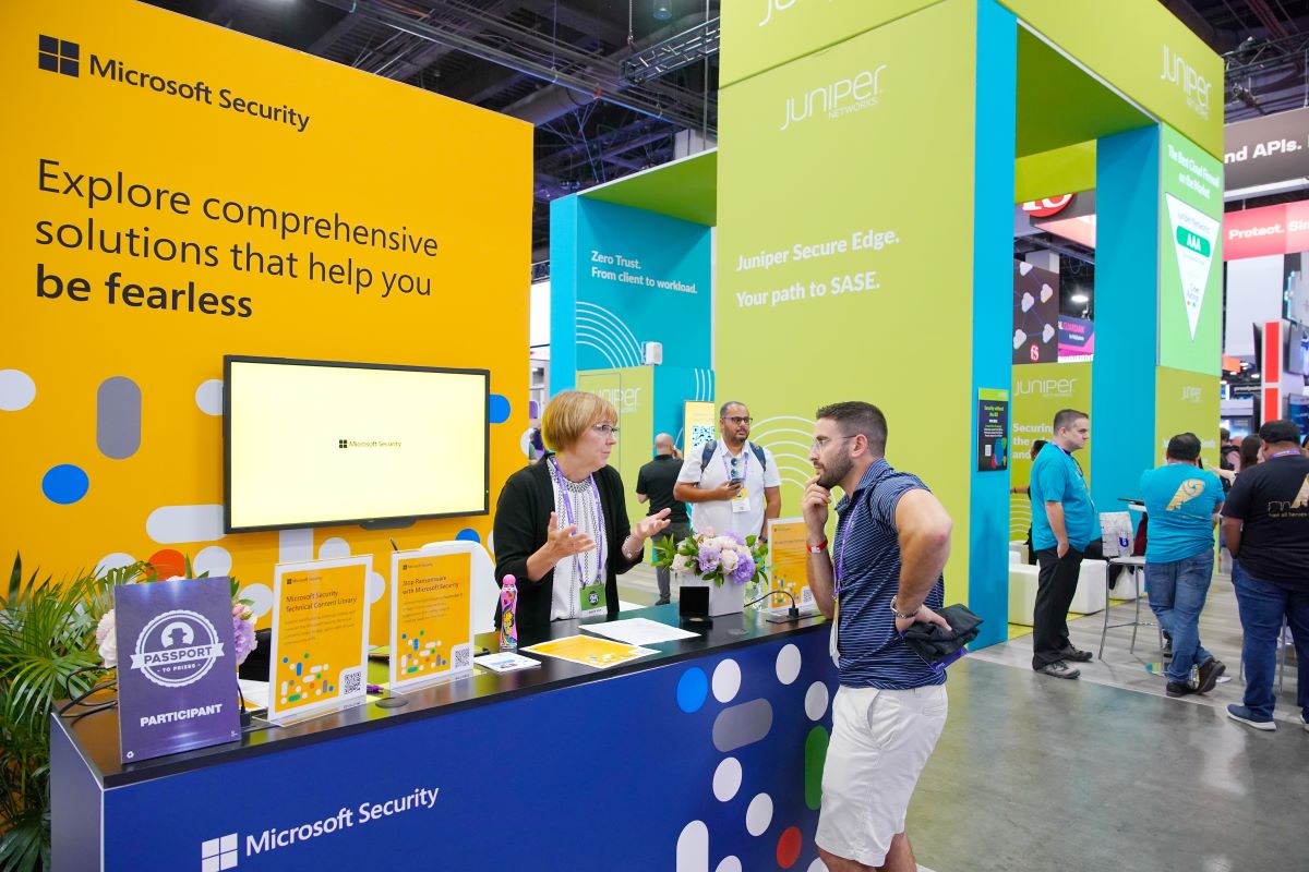 Woman at a Microsoft Security conference booth talks with an attendee