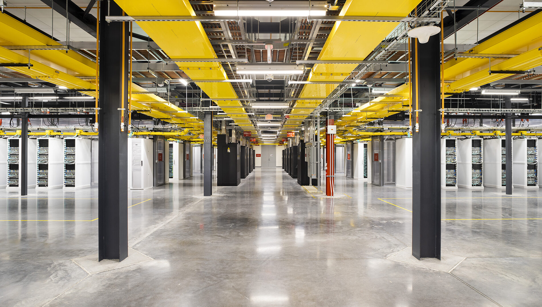 A panorama of a datacenter looking down an aisle with server racks on either side
