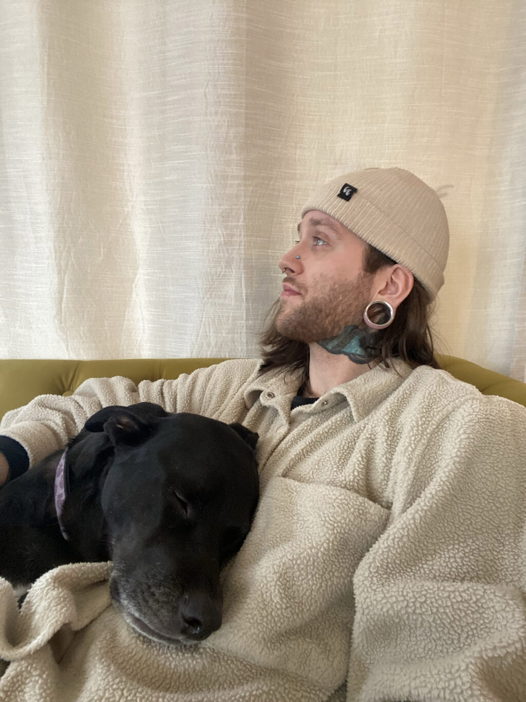 Man sits with a dog