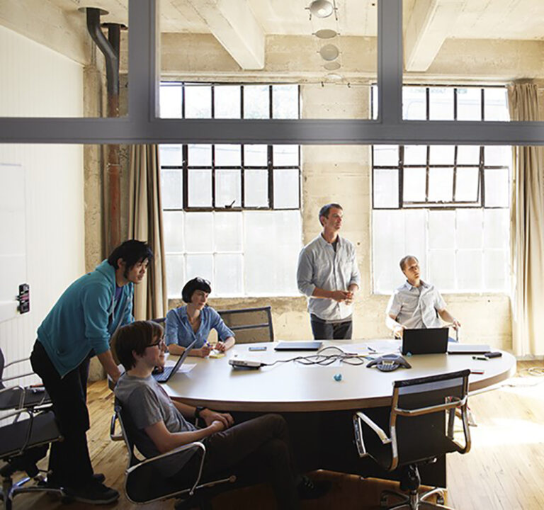 Six people meeting in a loft office