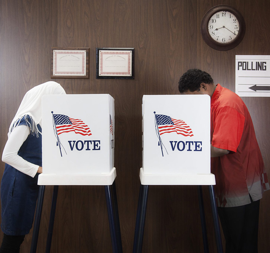 Woman and man in voting booths