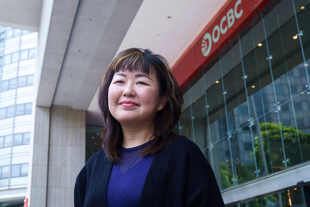 Woman standing in front of an OCBC bank branch