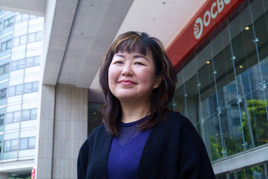 Woman standing in front of an OCBC Bank branch