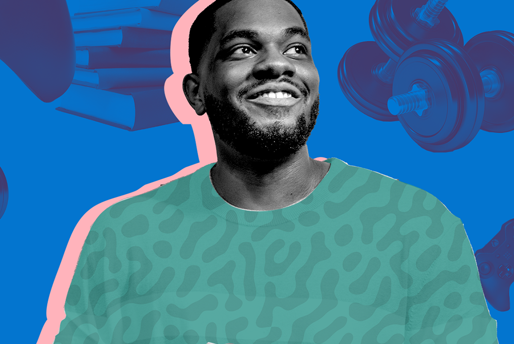 Smiling man wearing a green sweater against a blue background