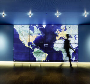 Shadow of a person walking by a map of the world in Microsoft's cybercrime center