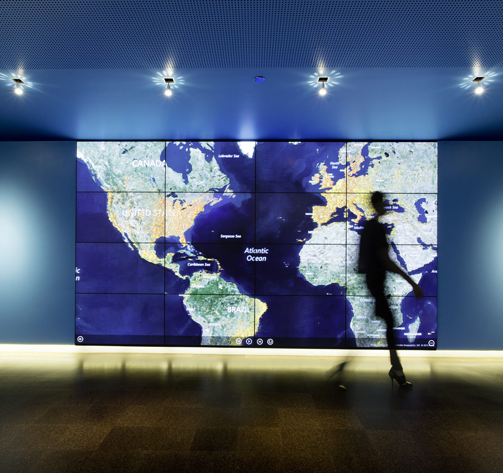 Shadow of a person walking by a map of the world in Microsoft's cybercrime center