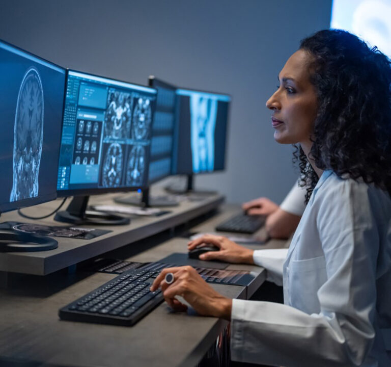 Woman studying computer screen displaying radiology results