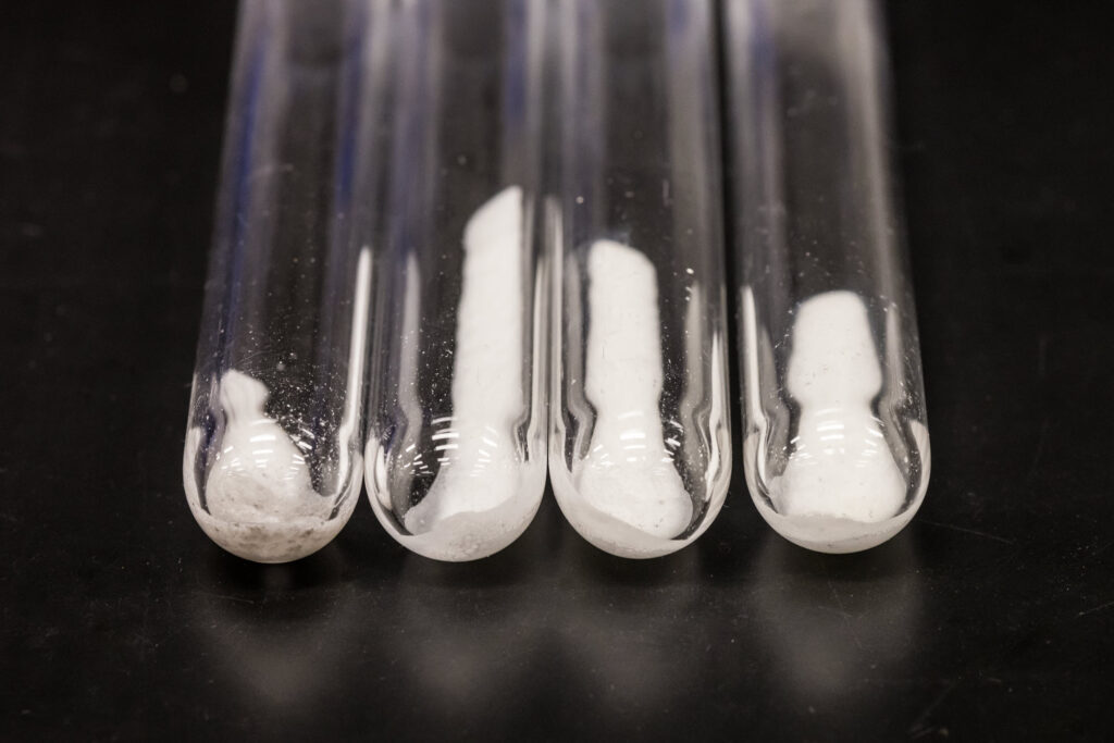Test tubes contain samples of the new material, which looks like fine white salt.