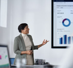 Woman presenting financial data at a meeting
