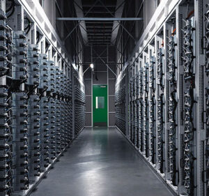 View down a corridor of a datacenter full of server racks
